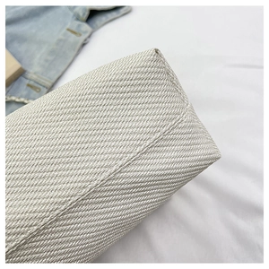 Detailed macro shot showing the fine twill woven texture of the white commuter handbag