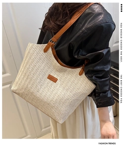 Close-up of the vintage woven tote bag featuring leather trim and fashion brand tag detail