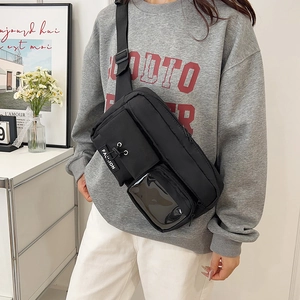 Versatile black nylon crossbody bag with fashion tag and clear PVC compartment for men and women