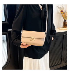 Detailed view of beige PU leather crossbody bag with elegant gold double-ring metal buckle