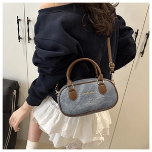 Mini denim crossbody bag with brown leather trim shown on model for size and fit