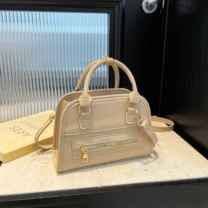 Minimalist beige lychee grain leather Boston bag with gold zippers and detachable strap