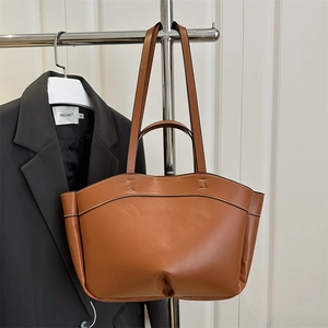 Brown leather tote bag for women featuring a spacious design and dual carry straps