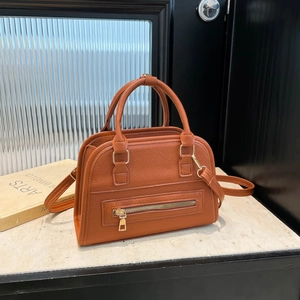 Orange brown litchi pattern leather Boston bag with gold zippers and adjustable strap