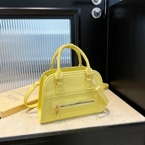 Minimalist lemon yellow tote bag with pebble leather texture and gold hardware details