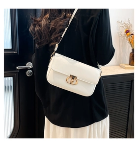 Detailed view of white rectangular crossbody bag featuring a golden double-ring metal lock