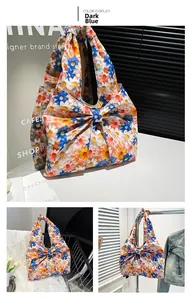 Detail of floral tote bag with daisy prints and a large bow in lifestyle scenes