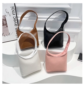 Detailed woven texture of underarm bucket bags in brown, black, white, and pink
