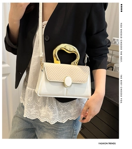 Chic patchwork crossbody bag with golden irregular metal handle and woven flap detail