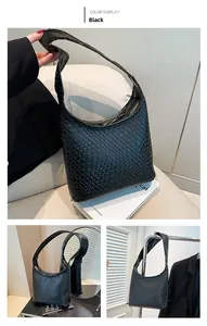 Detail of black woven leather hobo bag showing intricate Intrecciato texture and wide strap