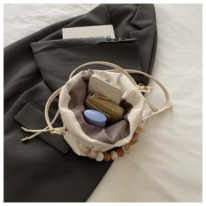 Top view of cream white bucket bag showing inner space for phone, wallet and cosmetics
