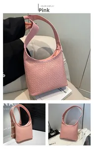 Macro detail of the pink hobo bag showing intricate woven texture and leather handle