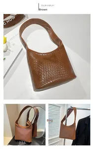 Detail of brown woven hobo bag with high-quality faux leather texture and wide strap