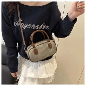 Detail of vintage canvas Boston bag with leather trim and adjustable crossbody strap