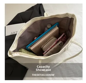 Interior view showing the large capacity of the beige tote bag with daily essentials