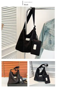 Detail view of black corduroy tote bag set with textured finish and brand logo patch