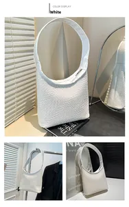 Detail of the white woven texture and zipper closure on this soft PU leather tote bag