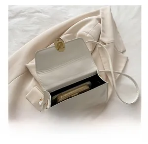 Internal view of beige leather small flap bag showing smartphone storage capacity