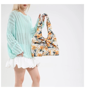 Floral canvas tote bag featuring a large decorative bow and vibrant orange flower patterns