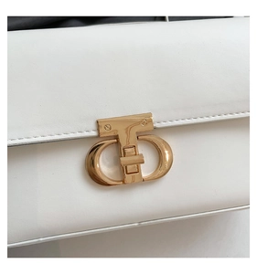 Detailed macro view of the white PU leather bag featuring a polished gold interlocking buckle
