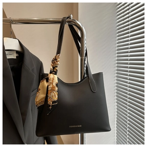 Detail of black matte tote bag featuring a beige printed scarf and Fashion & Bags text
