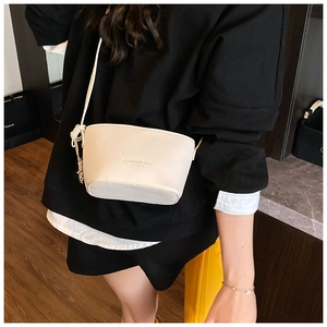 Close-up of cream lychee texture bucket bag featuring embossed Fashion & Bags logo