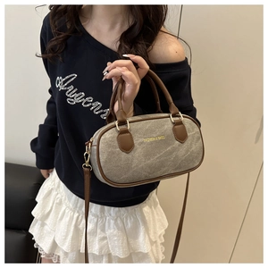 Detail of color-block canvas and leather handbag with Fashion & Bags logo and gold zipper