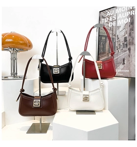 Detailed close-up of semi-circle shoulder bags with metal S buckle and knotted straps