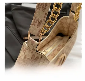 Detail of gold metal chain strap and luxury litchi grain leather with letter print