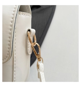 Detailed close-up of white PU leather bag side with golden metal D-ring and precise stitching