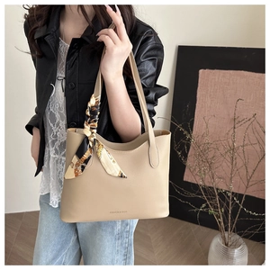 Detail of beige tote bag featuring a printed silk scarf and FASHION & BAGS lettering