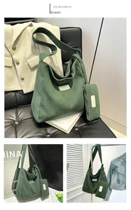 Detail of dark green corduroy hobo bag set with matching pouch and white square logo