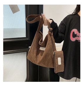 Detail of vintage brown corduroy tote bag with adjustable strap and small zipper pouch