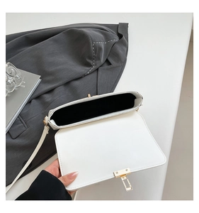 Detailed view of the open white PU leather square handbag with a gold metal lock