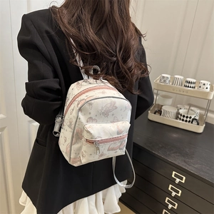 Mini cream backpack with pink butterfly prints and silver straps for women