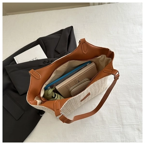 Interior view of beige straw tote bag showing large capacity for tablet and accessories