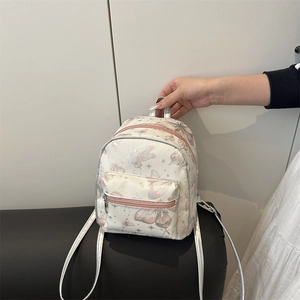 Mini preppy backpack in cream with pink butterfly prints and silver metal zippers