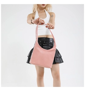 Detail of pink woven leather hobo bag showcasing intricate intrecciato texture and design