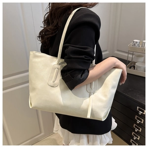 Side view of cream-white large capacity tote bag worn by model for office and daily use