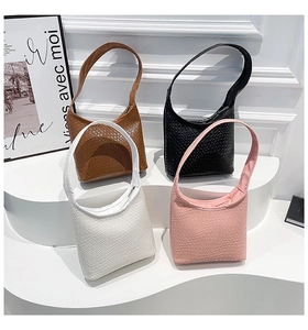 Four colorful woven texture PU leather crescent hobo bags arranged on a white display stand