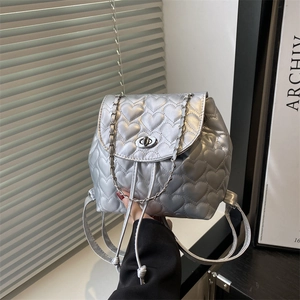 Silver mini backpack with heart quilting, metal chain detail and twist lock closure