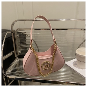 Detailed close-up of pink hobo bag featuring textured leather and gold M letter logo