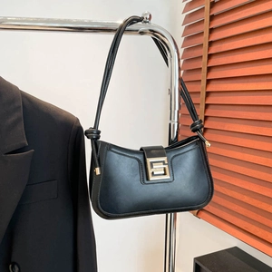 Elegant black leather hobo shoulder bag with a large metallic geometric clasp detail