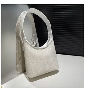 Detail of white woven leather hobo bag with a silver zipper and square texture