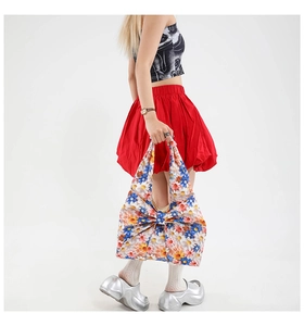 Floral tote bag with large bow detail and colorful daisy print on lightweight fabric
