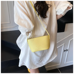 Close-up of bright yellow litchi texture bucket bag with embossed Fashion & Bags logo