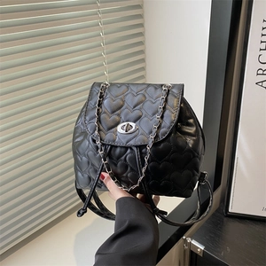 Chic black heart-quilted backpack with silver chain strap and metal turn-lock closure