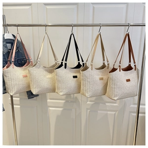 Five assorted woven straw tote bags with contrast leather straps and Fashion label detail