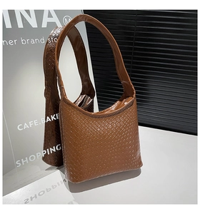 Close-up of the intricate woven texture and high-quality brown leather on the hobo bag