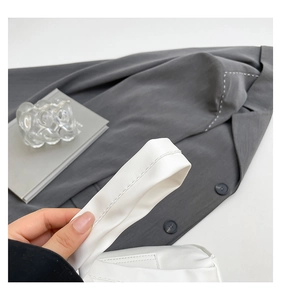 Close-up of white leather shoulder strap featuring high-quality stitching and smooth texture
